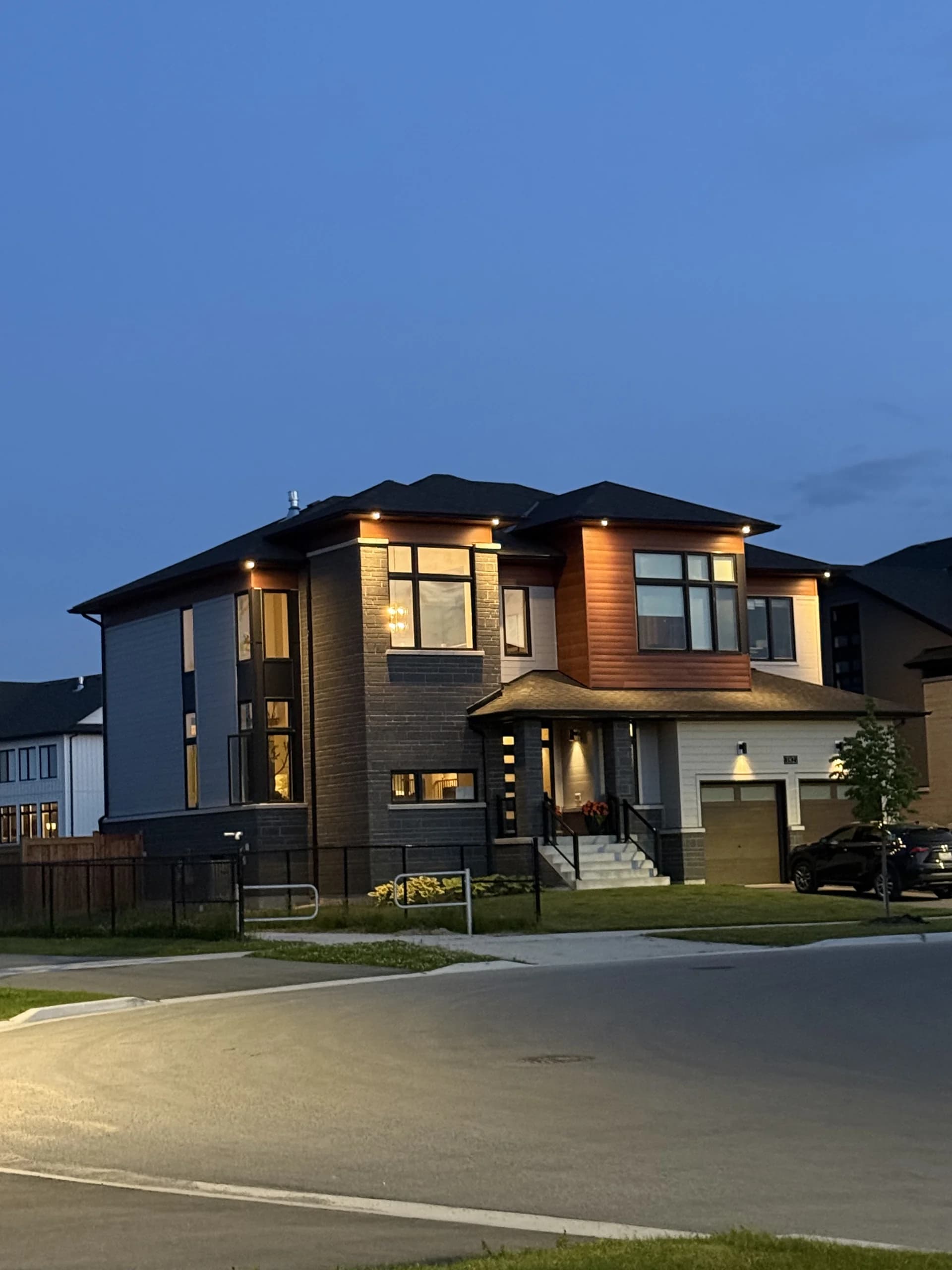 Top Choice Electrical pot-light install on a Newmarket home at dusk, every soffit and porch light glowing